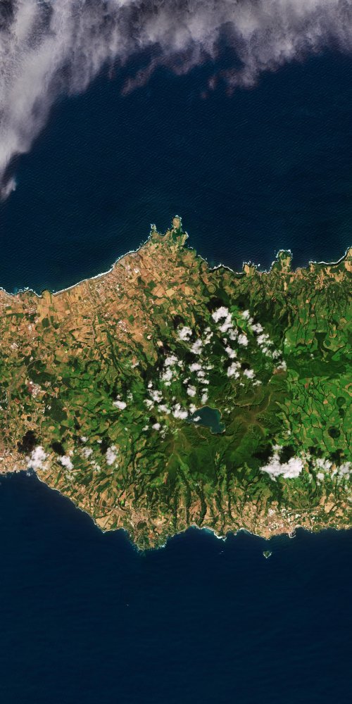 Car driving on a coastal road in São Miguel